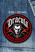 Dracula vampire circle patch with gothic horror design, red black colors, bats, crosses, and Blood Never Lies text on denim jacket